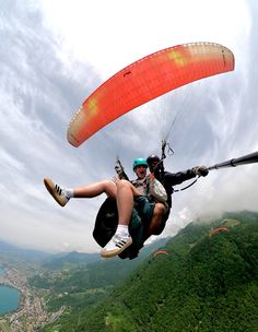 two people are paragliding in the mountains