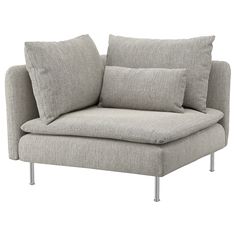 a gray couch with two pillows on it and some metal legs in front of it