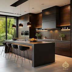 a modern kitchen with an island and bar stools