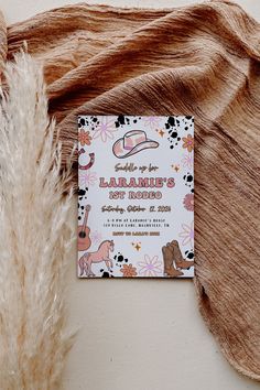 a card that is sitting on top of a fur rug next to a piece of cloth