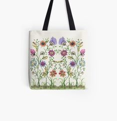 a tote bag with flowers painted on the front and side, all over it