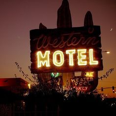 the neon sign for western motel is lit up