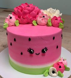 a watermelon cake with pink flowers on top