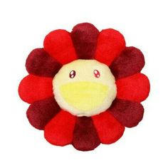 a red and yellow flower with eyes on it's head, sitting in front of a white background