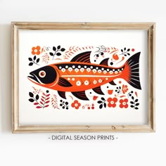 an orange and black fish with flowers on it's side in a wooden frame