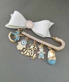 a close up of a key chain with charms on it and a bow tie around the neck