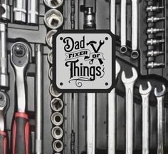 there are many wrenches and other tools in the storage area together, including one for dad's day