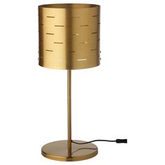 a gold lamp with a black cord plugged into the base and a white background