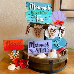 there is a sign that says mermaid have more fun and some decorations on the table