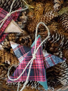 some ornaments are sitting in a basket with pine cones and twine on the table