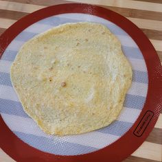 a tortilla sitting on top of a red plate