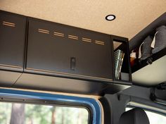 the inside of a vehicle with cabinets and shelves