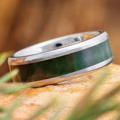 a wedding band that has been made to look like it is on top of a piece of wood