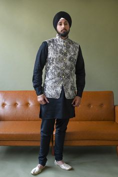 The perfect accent to make any kurta pajama to pop in this metallic black and gold Sidhu Vest. Designed with botanical-like floral pattern throughout, style for any evening event and perfect for a South Asian Sangeet or Reception night! Details Satin Lining Gold Button Closures Dry Clean Item #102602-4 Ethically produced + designed in NYC Black Nehru Jacket With Zari Work, Black Bandhgala Straight Kurta, Black Straight Kurta Bandhgala For Festive Season, Festive Black Straight Kurta Bandhgala, Designer Black Straight Kurta, Black Kurta With Gold Embroidery For Diwali, Elegant Black Nehru Jacket For Diwali, Elegant Black Bandhgala Straight Kurta, Fitted Black Bandhgala Straight Kurta