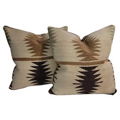 two brown and white pillows sitting next to each other