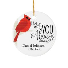 a ceramic ornament with a cardinal on it's back and the words i am with you always written in red