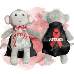 two teddy bears with red and black ribbons on their backs, one holding the other's hand