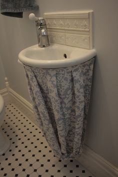 a white sink sitting next to a toilet in a bathroom