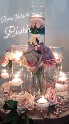 there are many candles and flowers in the glass vases on the table with each other