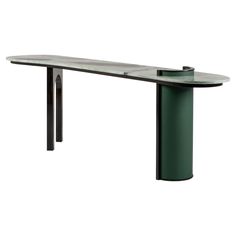 a black and green table sitting on top of a white floor next to a metal pole