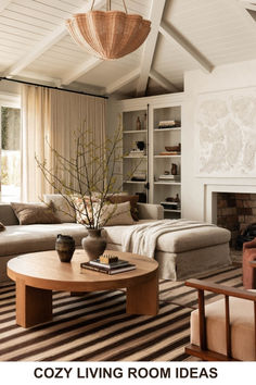 a living room filled with furniture and a fire place in front of a couch, coffee table