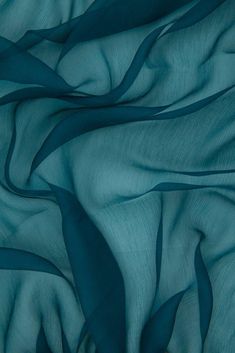 Teal Silk Crinkled Chiffon Fabric is a lightweight fabric with a pronounced crinkled texture running lengthwise down the fabric. The word "chiffon" is French in origin and means "cloth". Our Silk Crinkled Chiffon comes in a wide range of colors, and it is utilized for bridal, eveningwear, overlays, lingerie, pants, blouses. Purchase fabric by the Yard at NY Designer Fabrics. The fabric measures 42 inches in width. Silk Chiffon Fabric, Mood Fabrics, Buy Fabric, Deep Teal, Sheer Chiffon, Fabric Online, Teal Colors, Fashion Fabric, Sheer Fabrics