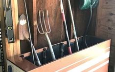 the inside of a horse trailer with many different items in its storage compartment and tools hanging on the wall