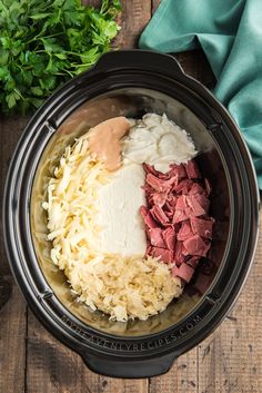 the ingredients for this slow cooker meal include meat, cheese and gravy