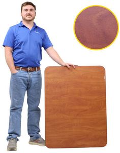 a man standing next to a large wooden board