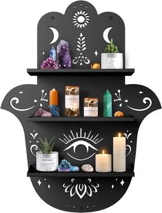 two shelves that have candles, rocks and other items on top of each shelf in the shape of an eye