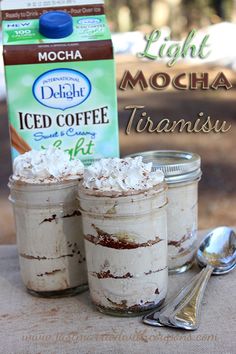 two jars filled with food sitting on top of a table next to a carton of light mocha