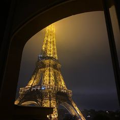 the eiffel tower is lit up at night