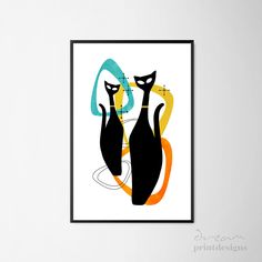 two black cats sitting next to each other in front of a wall mounted art piece