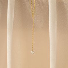 Accentuate a beautiful neckline with our Pearl Lariat Y Necklace. The dainty chain necklace with a long dangling Pearl charm is the perfect choice for a glamorous evening event. Once you wear this out, you will be unstoppable. Material: High Quality Solid 925 Sterling Silver Finish: 18K Gold ∙ Sterling Silver Featuring a ~9mm Pearl Charm on a ~3 inch long Lariat Singapore Twist Chain Necklace, adjustable from 16 to 18 inches Part of our Pearl Collection SKU: RR-NR181 Elegant Necklace With Delicate Chain And Long Drop, Minimalist Charm Necklace For Party With Delicate Chain, Minimalist Charm Necklace For Party, Pearl Pendant Lariat Necklace, Dainty Lariat Necklace With Teardrop Pendant, Minimalist Lariat Necklace With Pearl Pendant, Elegant Lariat Charm Necklaces, Minimalist Teardrop Lariat Necklace With Adjustable Chain, Dainty Teardrop Lariat Necklace With Adjustable Chain