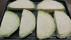 four pieces of artichoke sitting on top of a baking pan next to each other