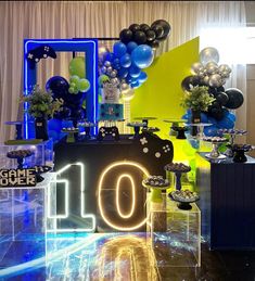 the table is set up with balloons, candles and decorations for an 10th birthday party