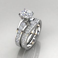 a wedding ring set with two matching bands and a round diamond on the side, in white gold