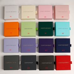 many different colored books are arranged on a white surface with the words century hot written in red, green, blue, and pink