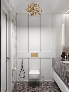 a bathroom with marble floors and white walls, gold accents on the fixtures is shown