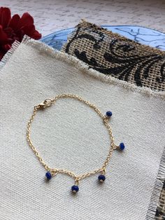 Beaded Sapphire Bracelet. This beautiful beaded sapphire bracelet features 5 faceted sapphires wire wrapped onto a gold-filled chain. The sapphires are approximately 2-3 mm. The bracelet is finished with a gold-filled lobster clasp. Sapphire is the birthstone of September. Your bracelet will arrive in a gift box. If this is a gift, I would be happy to include a card with your personal message - just let me know in the message section at checkout. Adjustable Faceted Sapphire Bracelets, Adjustable Faceted Sapphire Bracelet, Faceted Beads Dangle Bracelets As Gift, Dainty Blue Bracelets With Faceted Beads, Sapphire Beaded Bracelets With Faceted Beads For Gift, Gift Sapphire Beaded Bracelets With Faceted Beads, Adjustable Sapphire Beaded Bracelets With Gemstones, Faceted Sapphire Beaded Bracelets As Gift, Sapphire Round Faceted Bead Bracelets