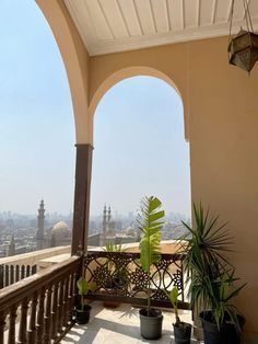 a balcony with potted plants on it