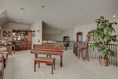 a living room filled with furniture and a piano