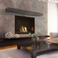 a living room with a couch, coffee table and fire place in the fireplace area