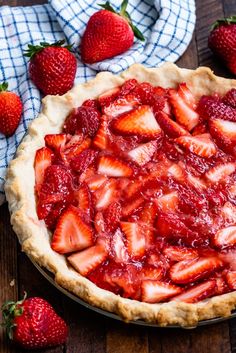 a pie with sliced strawberries on top