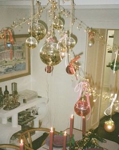 a dining room filled with lots of christmas decorations and candles on top of a table