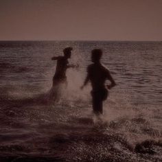 two people splashing in the ocean water