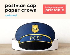 the postman cap paper crown is on top of a wooden table next to a white wall