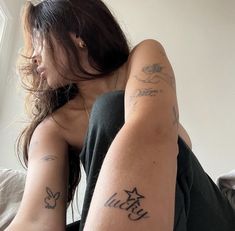 a woman with tattoos on her arms and legs