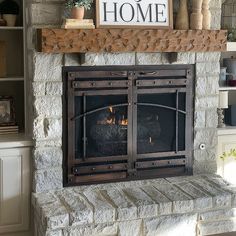 a fireplace with a sign above it that says home