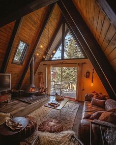 a living room filled with furniture and a fire place in the middle of a loft